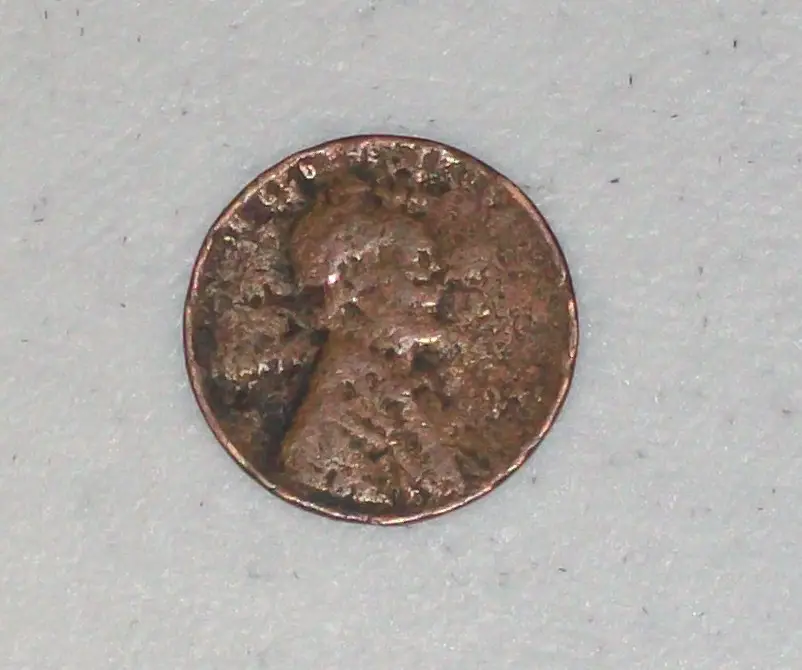 This 1941 penny has countless pits and blackened areas all across the surface.