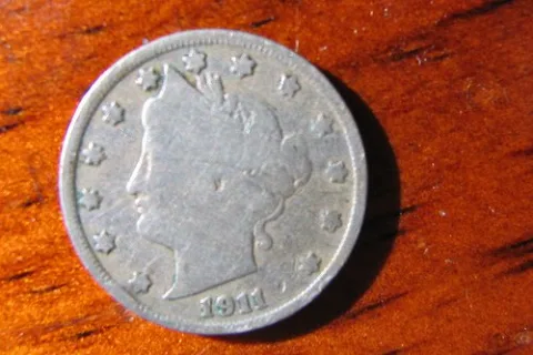 Example of a well-worn Liberty Head nickel from 1911, one of the later years of the Barber design.