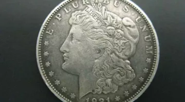 This 1921 Morgan dollar coin has a lower value than its 1921 Peace dollar counterpart. 