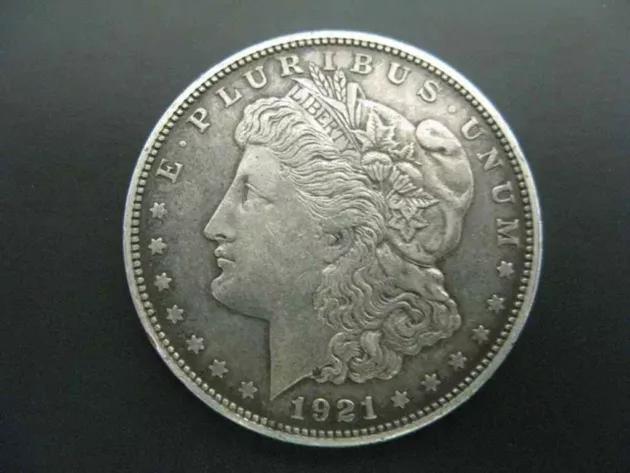This 1921 Morgan dollar coin has a lower value than its 1921 Peace dollar counterpart.