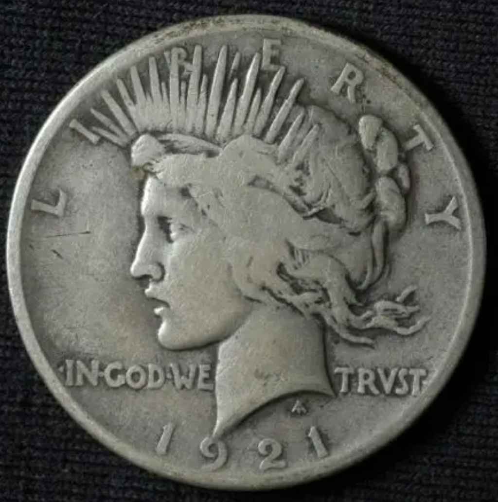 This is a 1921 Peace silver dollar. 
