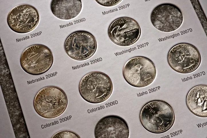 A 50 state quarters album or folder with 2 quarter slots for each U.S. mint example - the Philadelphia Mint and the Denver Mint