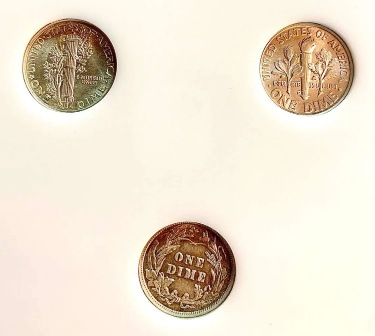 Pictured clockwise are reverse views of the Mercury dime, Roosevelt dime, and Barber dime. 