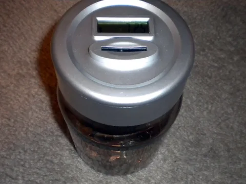 This spare change jar calculates the sum total of all the coins inside it.