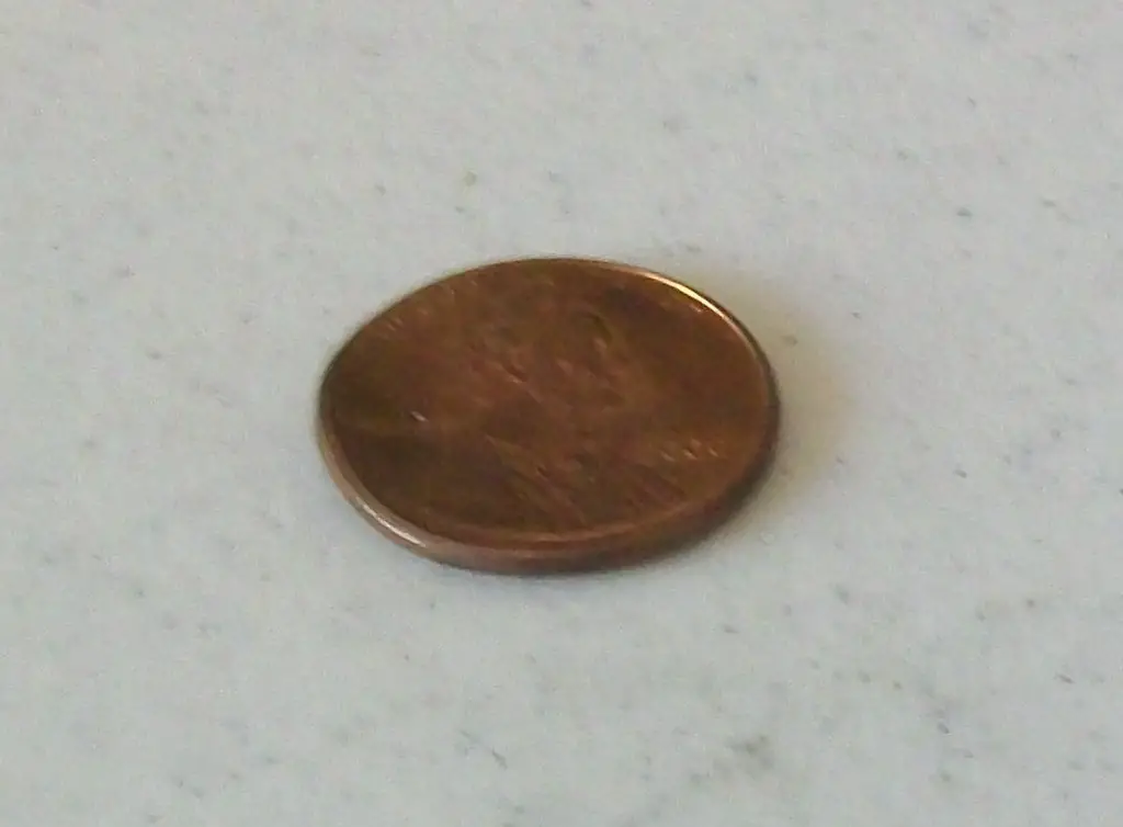 This 2000 penny is bent. The bend is most evident on the left side of the coin, where it reads LIBERTY.