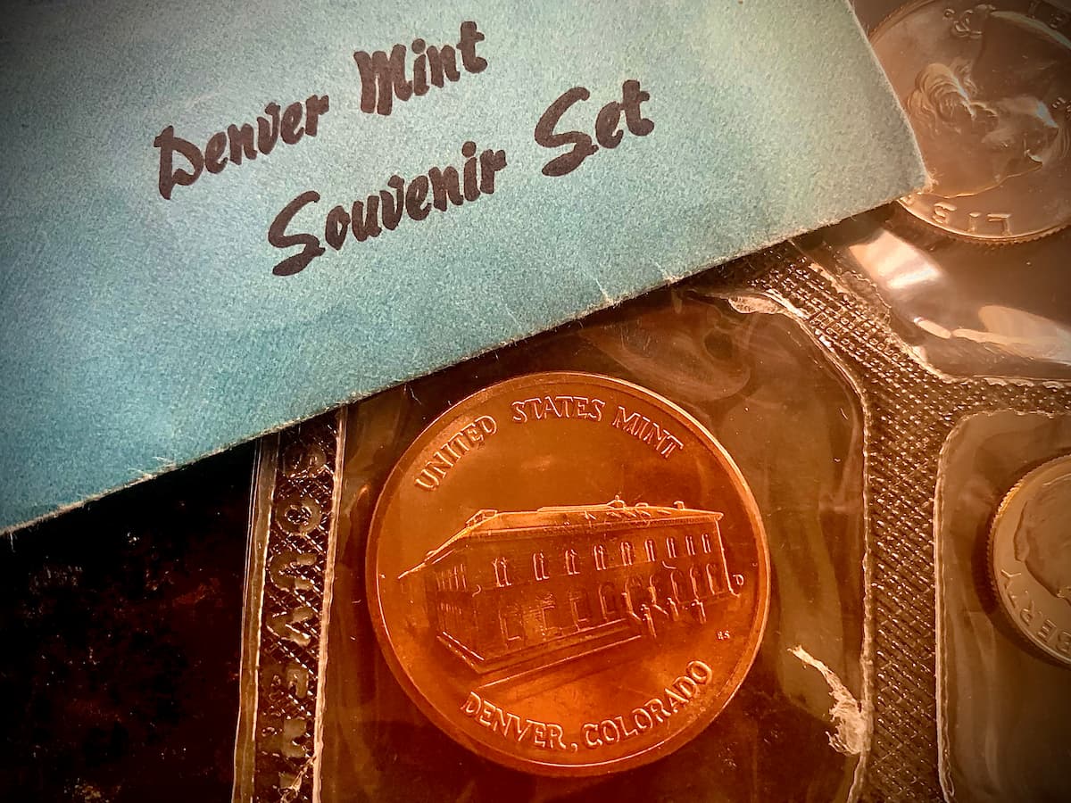 A Denver Mint coin set with a medal depicting the historic Denver Mint in Colorado.