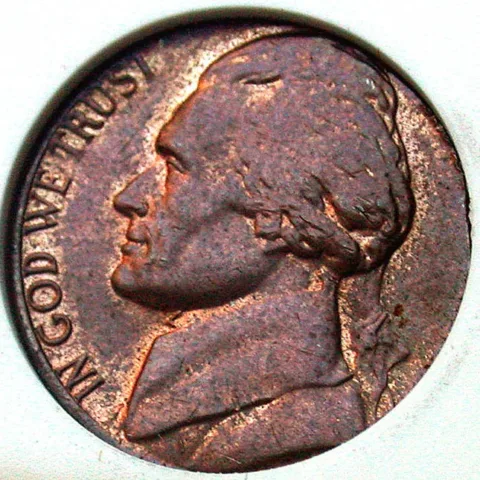 The wrong color is a sign that this is a nickel that was struck on a penny planchet.