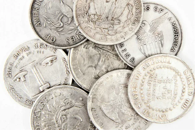 Several old U.S. silver dollars - including the class Trade Dollar.