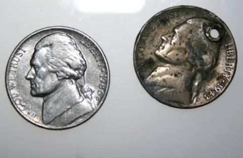 The 1943 Jefferson nickel has a common form of PMD -- Post Mint Damage -- a hole that wasn't there when the coin left the U.S. Mint.