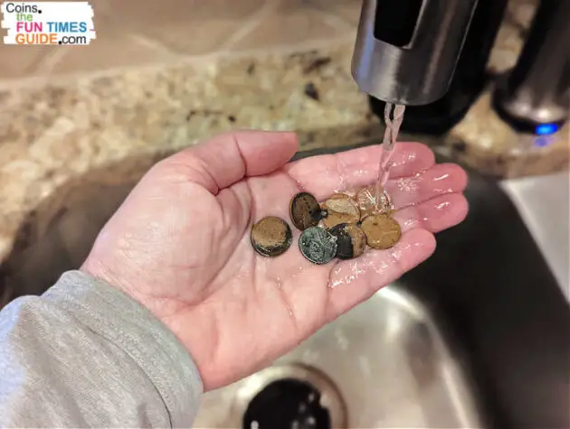 Proper coin cleaning only involves water -- nothing abrasive to scratch the coin's surface.