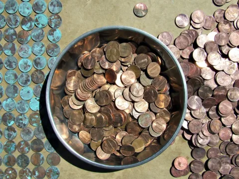old pennies collecting dust in a penny jar