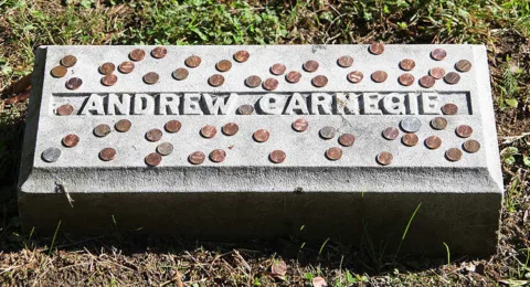 Learn why people put coins on some graves and not others.